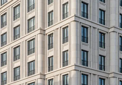 The stone facade and windows of a grand European congress hotel