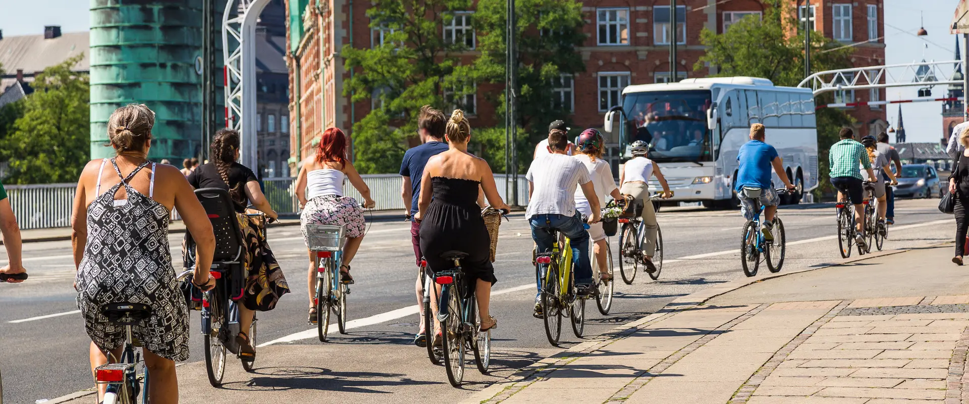 People riding bikes over a bridge in Copenhagen, Denmark