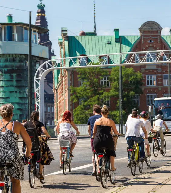 People riding bikes over a bridge in Copenhagen, Denmark