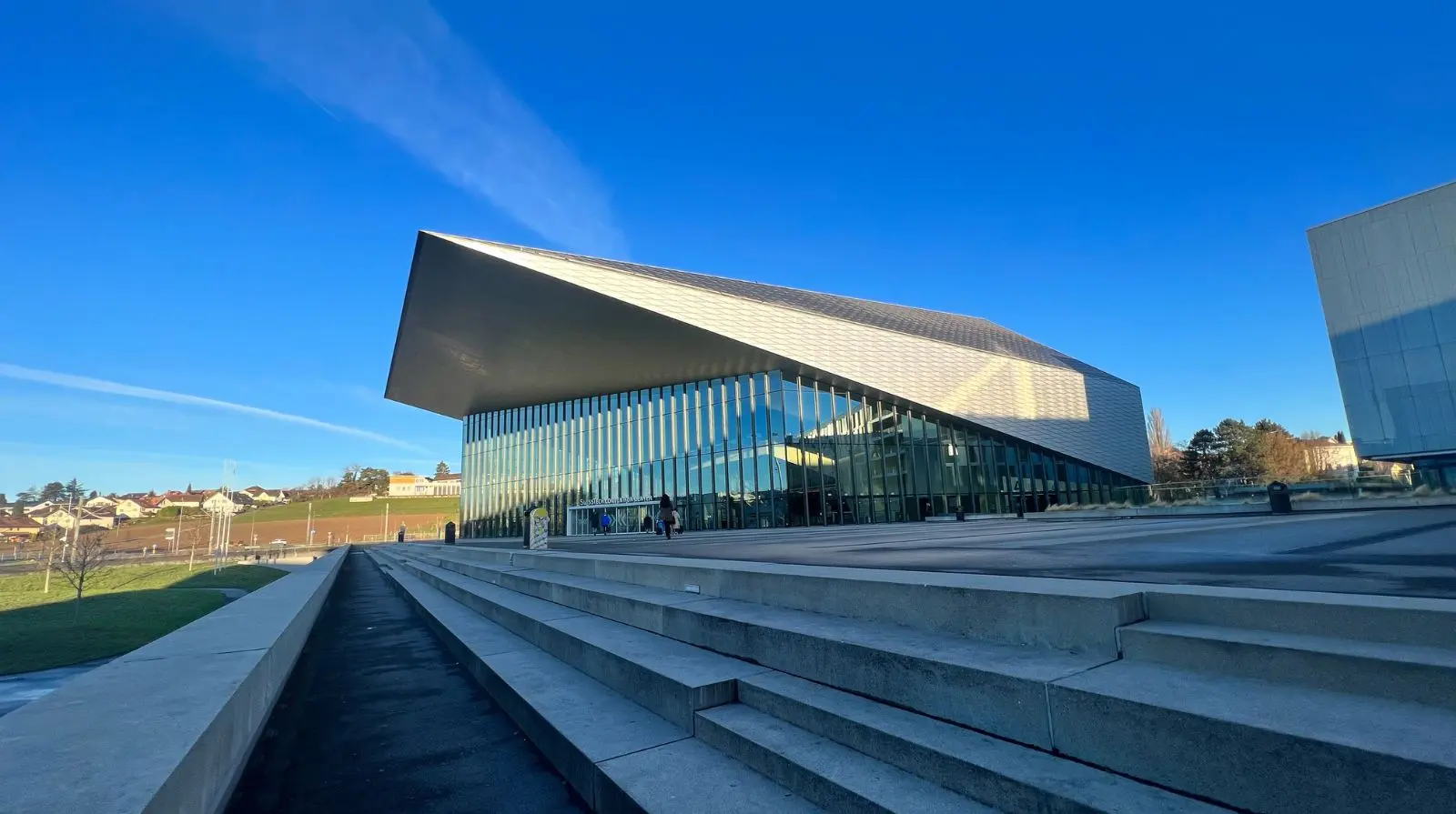 Modern conference venue exterior in Lausanne, Switzerland, hosting the WADA Annual Symposium.