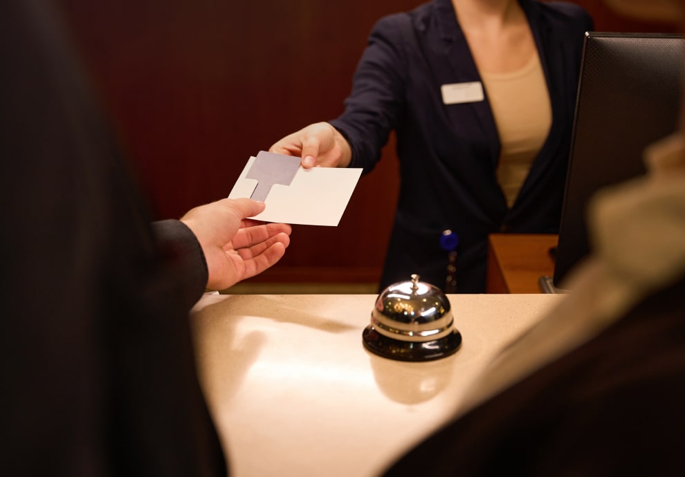 Receptionist passing a keycard to a guest in a hotel