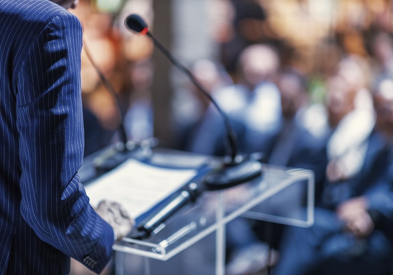KT - Men giving a speech