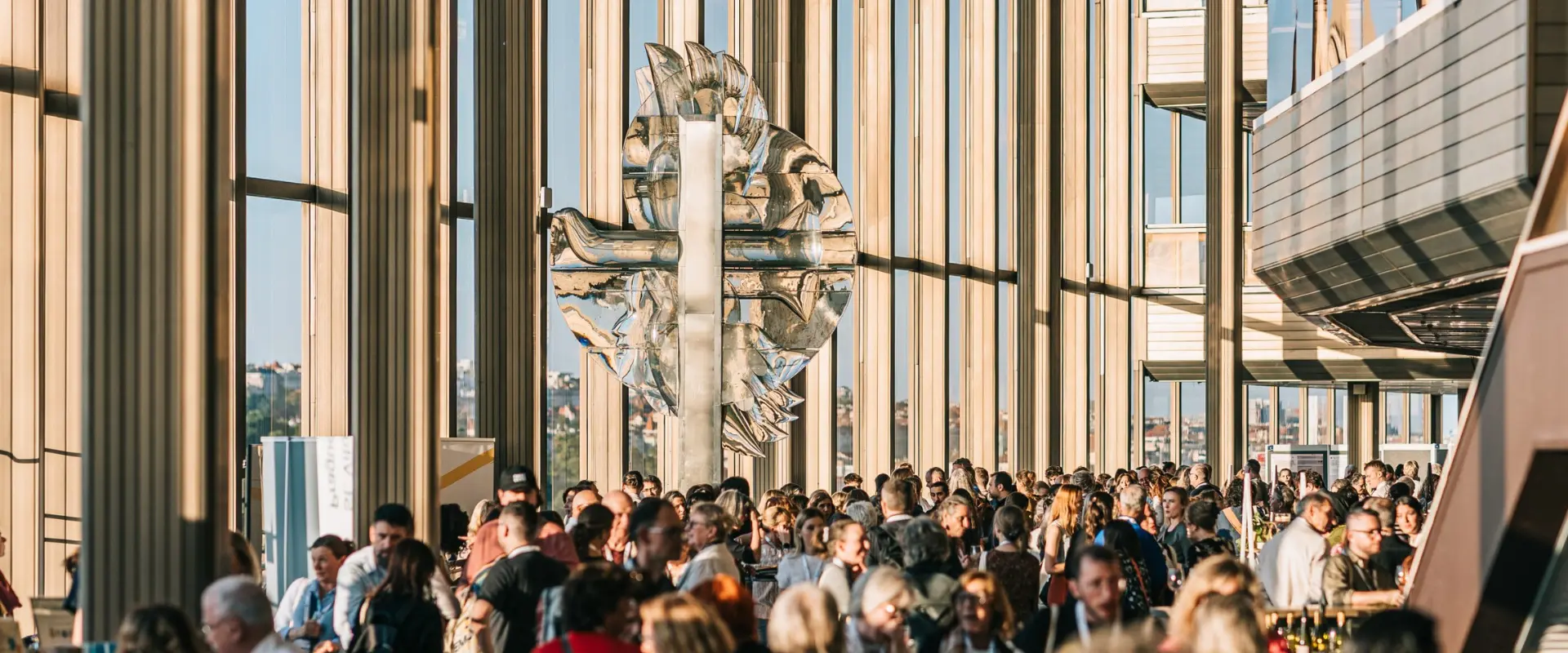 Delegates networking at the European Astronomical Society Congress in a modern glass venue