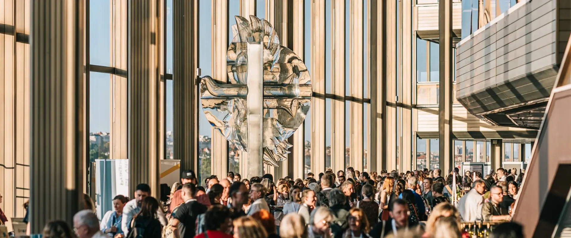 Delegates networking at the European Astronomical Society Congress in a modern glass venue
