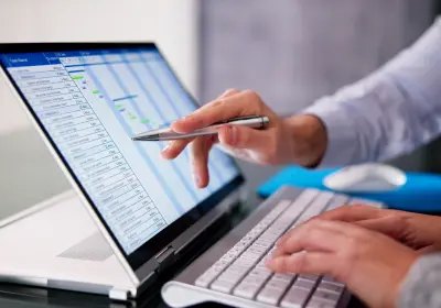 Event budget and financial data being reviewed on a laptop