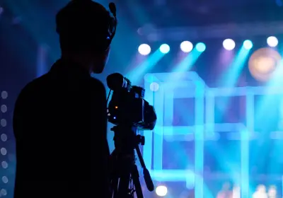 Camera operator filming a live conference presentation