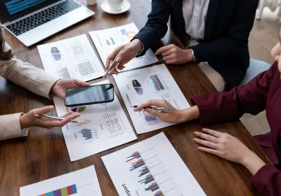 Team reviewing event performance reports and analytics on a desk