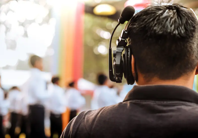 Event technician wearing a headset managing a live congress session