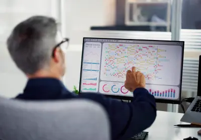 Analyst reviewing congress performance data on a large screen