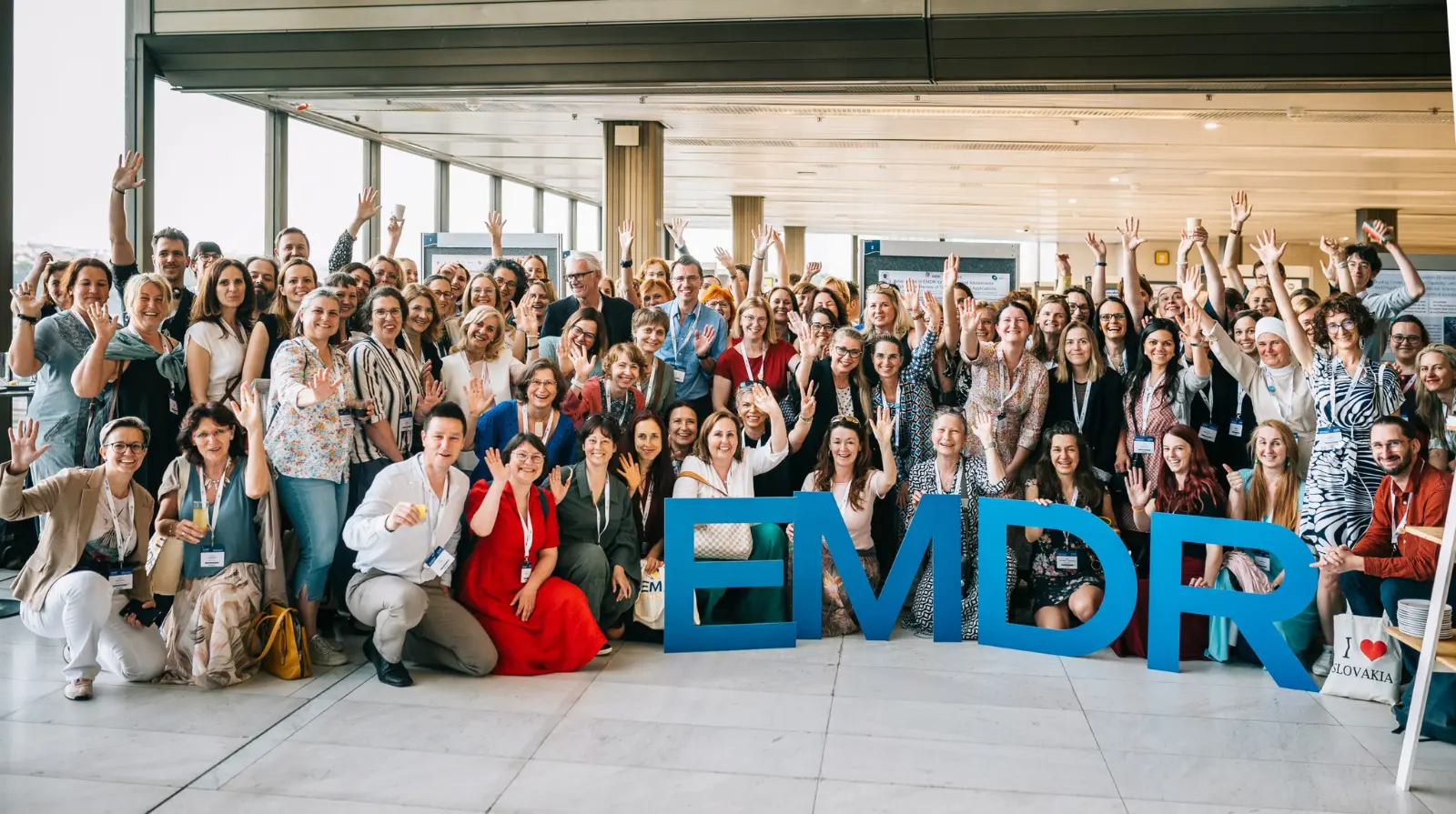 Delegates posing with large EMDR letter props at the EMDR Europe Research & Practice Conference 2025 in Prague