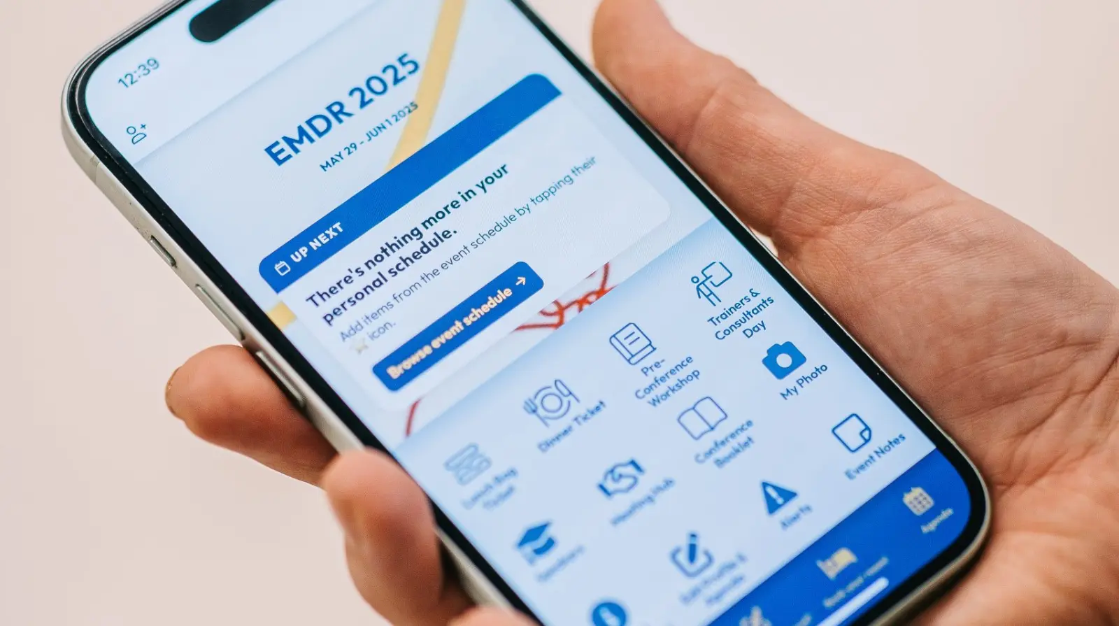 A delegate using the congress app on a smartphone at the EMDR Europe Research & Practice Conference 2025