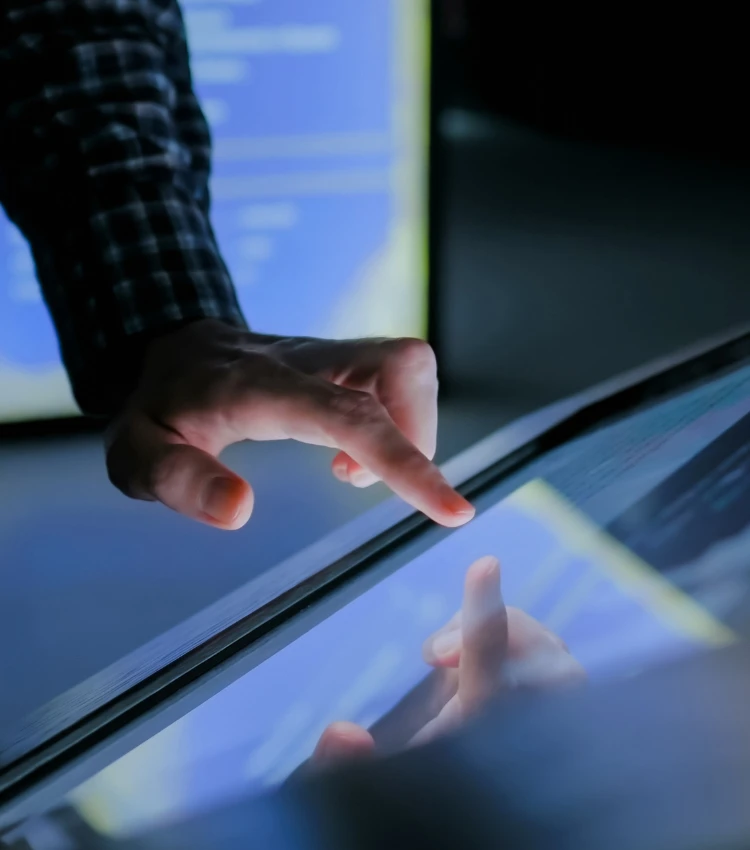 Education and technology concept - man using interactive touchscreen display of electronic kiosk 