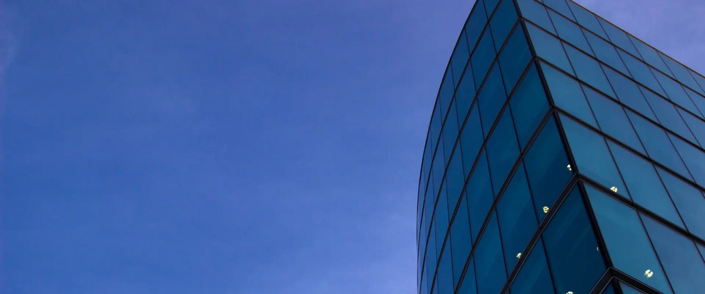 Glass windows of a building on a sky background