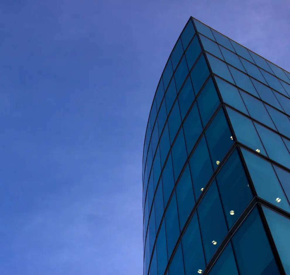 Glass windows of a building on a sky background