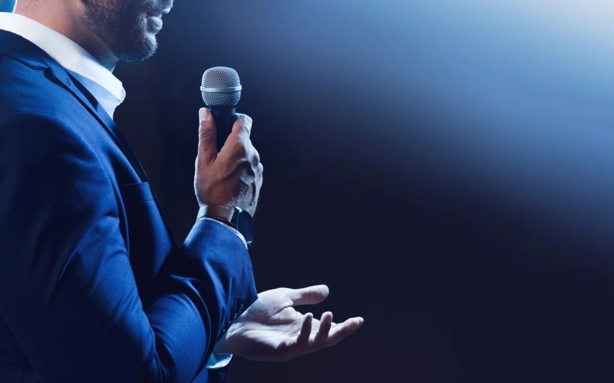Speaker holding a microphone