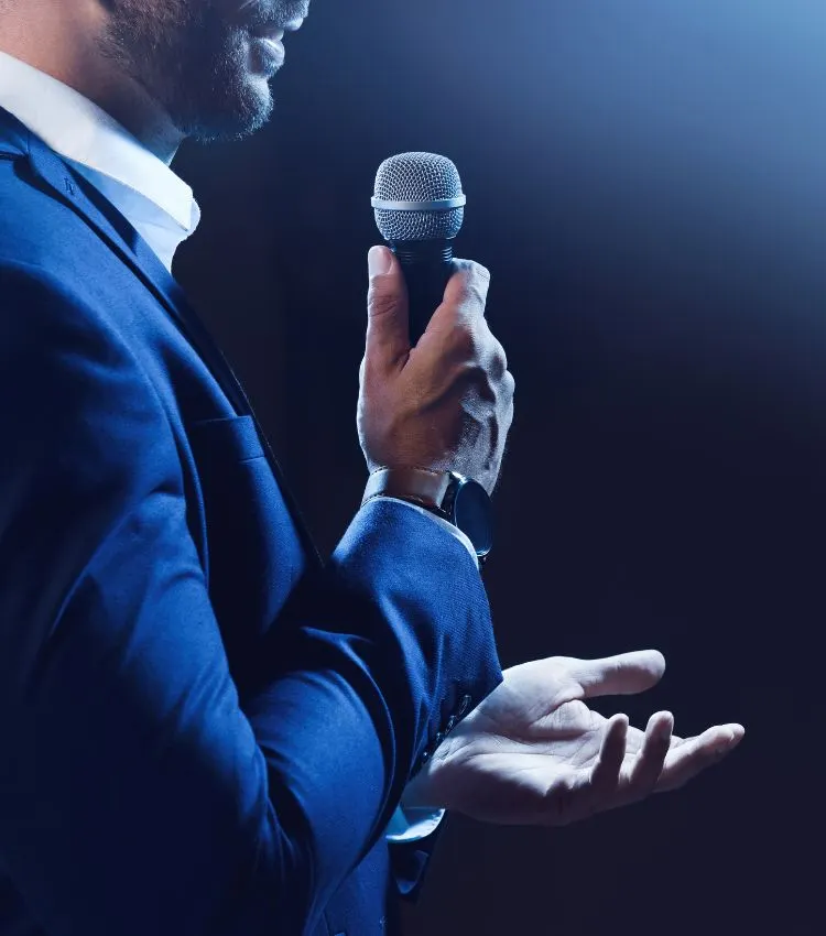 Speaker holding a microphone